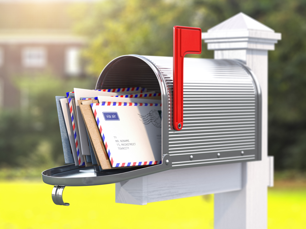 Open mailbox with letters on rural backgound.